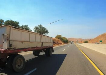 VideoHive Passing a double trailer freightliner truck on a highway in slow motion 45911552