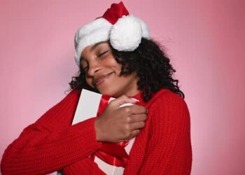 VideoHive Happy Woman in Santa Hat Holding Present Merry Christmas Concept 47712440
